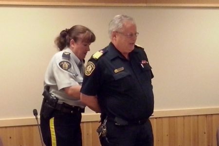 Top cop arrests fire chief at city council meeting